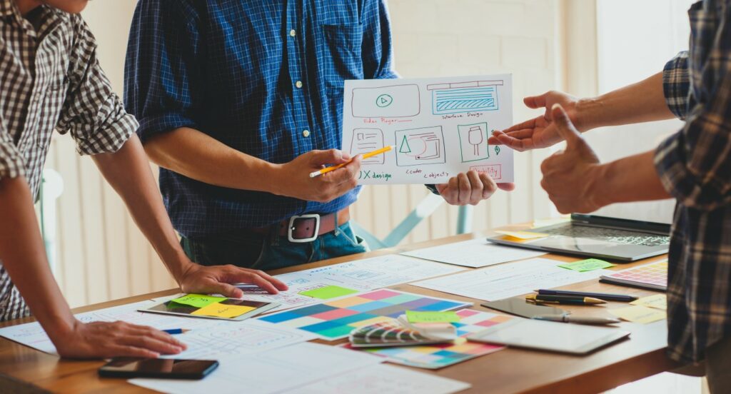 Website designers meeting to discuss and improve applications to