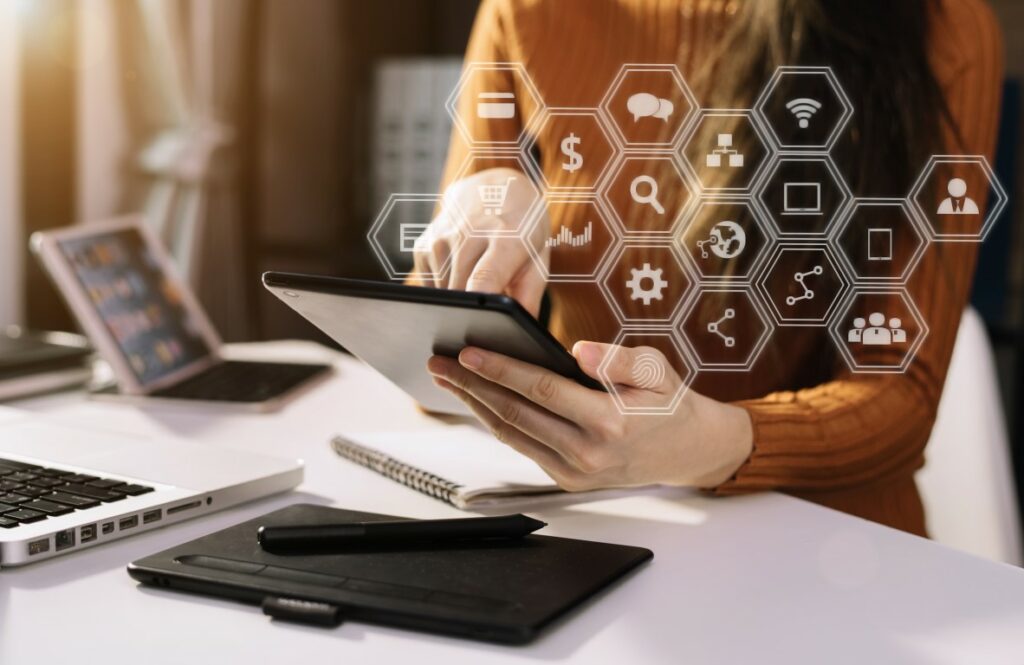 Businesswomen working with smart phone and laptop and digital tablet computer in office with digital marketing media in virtual icon.