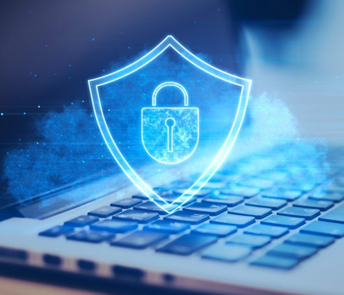 Close up of laptop keyboard with glowing shield hologram on screen. blurry desktop background. secure, protection, safety and web security concept. 3d rendering.